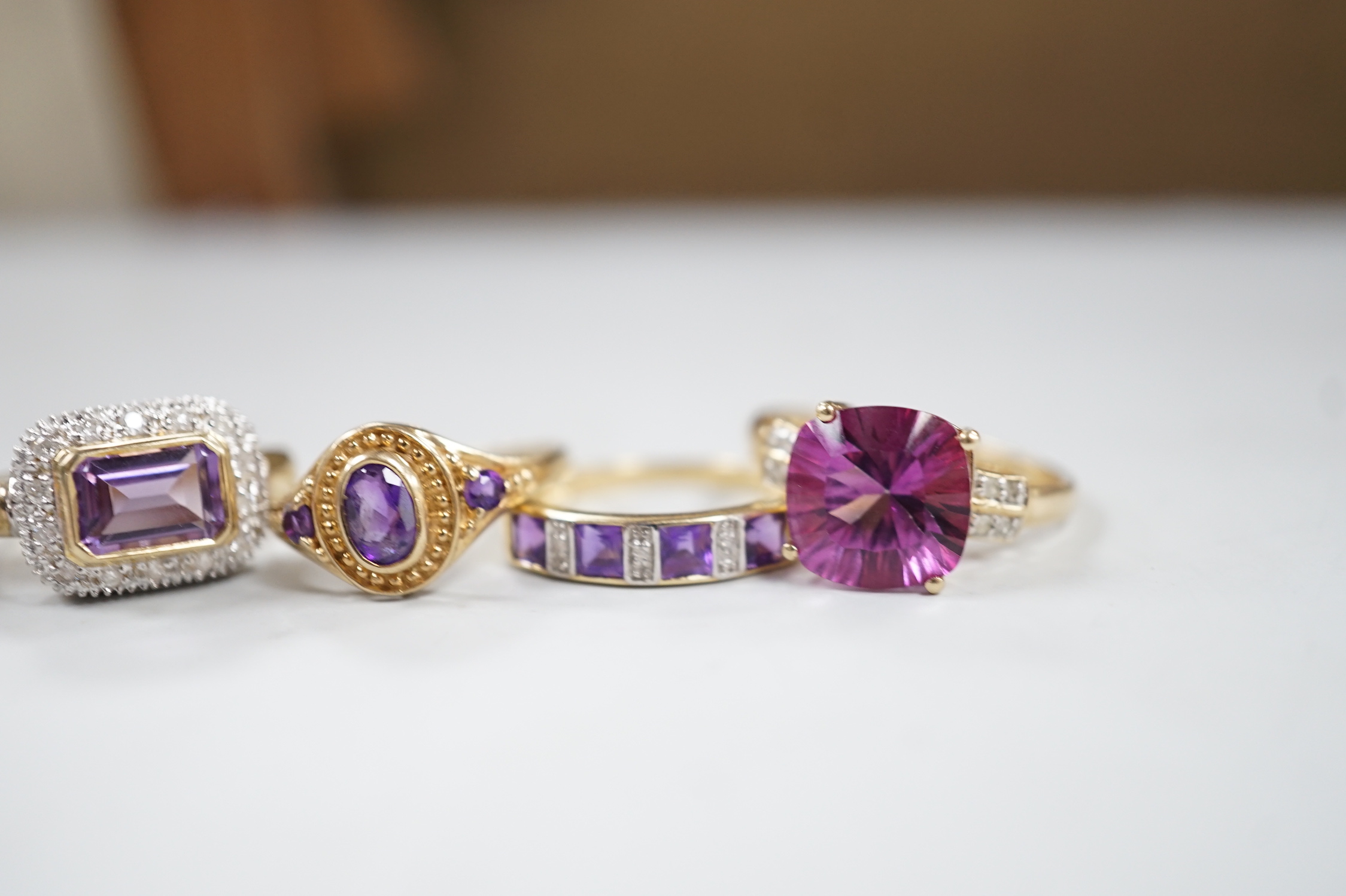 Five assorted modern 9ct gold and gem set dress rings, including diamond chip half hoop and amethyst and diamond chip half hoop, gross weight 12.6 grams.